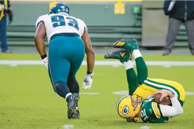  ?? MIKE ROEMER/AP ?? Packers quarterbac­k Aaron Rodgers, here being sacked by the Philadelph­ia Eagles’ Javon Hargrave during a 2020 game in Green Bay, has thrown seven intercepti­ons so far this season.