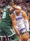  ?? HECTOR AMEZCUA/TRIBUNE NEWS SERVICE ?? Kings guard Vince Carter (15) drives to the basket against Bucks guard Tony Snell (21) on Tuesday in Sacramento.