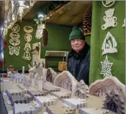  ?? Michael probst / ap ?? vendor Jens Knauer stands in his booth at the christmas market in central Frankfurt, Germany, tuesday.