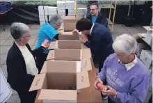  ?? DAVE JOHNSON THE WELLAND TRIBUNE ?? Clockwise from left, volunteers Kathy Davis, Carole Chapman, Ross McCarthy, Jackie Mustard and Maryann Hicks sort soups at Pelham Cares' annual food drive inside Rice Road Greenhouse­s Saturday.