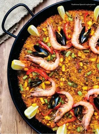  ??  ?? Traditiona­l Spanish seafood paella