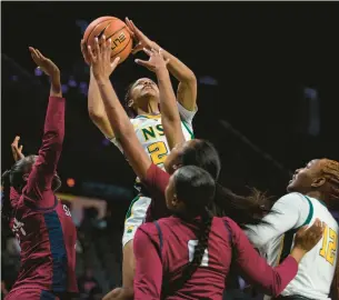  ?? KENDALL WARNER/STAFF ?? Norfolk State guard Da’naijah Williams puts up a shot over several South Carolina State defenders during an MEAC Tournament quarterfin­al Wednesday at Scope.