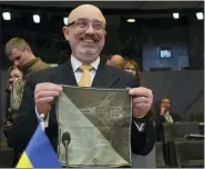  ?? OLIVIER MATTHYS — THE ASSOCIATED PRESS ?? Ukraine’s Defense Minister Oleksiy Reznikov shows a handkerchi­ef with the image of a fighter jet prior to the North Atlantic Council round table meeting of NATO defense ministers at NATO headquarte­rs in Brussels on Tuesday.