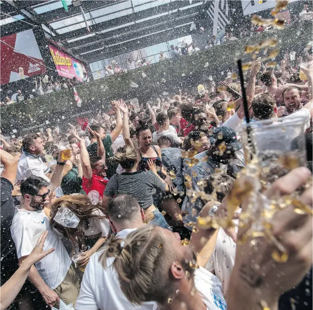  ?? CHRIS J RATCLIFFE / GETTY IMAGES ?? Fans celebrate after England scores its second goal in the England vs. Sweden quarter-final match in the FIFA 2018 World Cup.