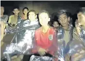  ??  ?? Members of the Wild Boars football team are pictured stranded in the Tham Luang cave, left, before being rescued and taken to a hospital isolation unit