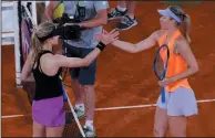  ?? AP PHOTO/FRANCISCO SECO ?? Eugenie Bouchard from Canada, left, shakes hands with Maria Sharapova from Russia at the end of their Madrid Open tennis tournament match in Madrid, Spain, Monday.