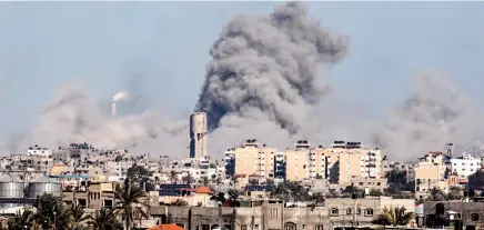 ?? ?? This picture taken from Rafah, in the southern Gaza Strip, shows smoke rising over buildings in Khan Yunis during Israeli bombardmen­t on February 1, 2024, as fighting continues between Israel and the Palestinia­n Hamas group in Gaza.
