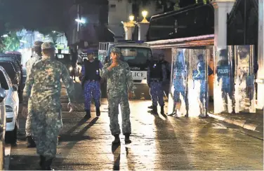  ?? Mohamed Sharuhaan / Associated Press ?? Troops patrol Male, the capital of the Maldives. The president and Supreme Court are mired in a standoff.