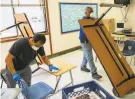  ?? Santiago Mejia / The Chronicle ?? Custodians Orlando Lavarias and Herman Flood clean and sanitize a classroom in Oakland last week.