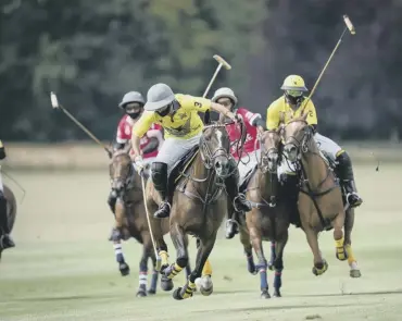  ?? PICTURE: MARK BEAUMONT ?? The early action in the King Power Gold Cup at Cowdray Park has been gripping