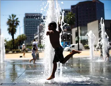  ?? RANDY VAZQUEZ — STAFF PHOTOGRAPH­ER ?? Noah Martinez, 6, jumps through the water fountains at the Plaza de Cesar Chavez in downtown San Jose on Wednesday.