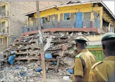  ?? Picture: AFP ?? REDUCED TO RUBBLE: Kenyan police officers at the scene after a seven-storey building collapsed on Monday night in Nairobi