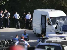  ?? AP PHOTO/EMILIO MORENATTI ?? Police bomb squad o cers work by a road near Subirats, Spain on Monday. A police operation was underway Monday in an area west of Barcelona, and a Spanish newspaper reports that the fugitive in the city’s van attack has been captured.