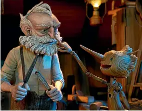  ?? ?? In del Toro’s adaptation of Pinocchio, Geppetto makes Pinocchio as a replacemen­t for the son he lost in the Great War.