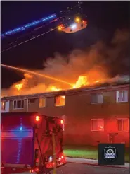  ?? PHOTO COURTESY OF WARREN SCANNER ?? Warren firefighte­rs, shown here putting out a May 2021 fire at Warren Manor apartments, have a new contract that increases pay and adds a cadet program.