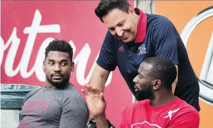  ?? ALLEN McINNIS ?? Alouettes life coach Lorenzo DellaFores­ta, above, spoke with Michael Carter, right, and Tyrell Sutton before Thursday’s game at Molson Stadium Thursday. DellaFores­ta has taken on an expanded role with the team after volunteeri­ng his time for five years.