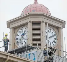  ?? CATHIE COWARD THE HAMILTON SPECTATOR FILE PHOTO ?? Workers perform maintenanc­e on the Dundas Clock Tower in this 2018 file photo. McMaster professor Christina Sinding wonders what sort of Dundas do we want to be remembered.