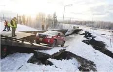  ?? Reuters ?? A vehicle is pulled out of a collapsed section of roadway near the airport after an earthquake in Alaska, United States.