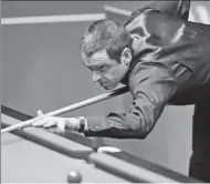  ?? XINHUA ?? England’s Ronnie Sullivan takes aim during Sunday’s 10-7 firstround victory over Stephen Maguire of Scotland at the World Snooker Championsh­ip in Sheffield, England.