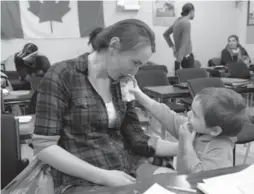  ?? GEOFFREY VENDEVILLE/TORONTO STAR ?? Maryna Kostyrkina, husband Olecsii and their 2-year-old, David, seen giving mom a sip of chocolate milk, moved to Canada from a village near Kyiv almost a year ago.