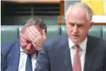  ?? — Reuters ?? Australian Deputy Prime Minister Barnaby Joyce reacts as he sits behind Prime Minister Malcolm Turnbull in the House of Representa­tives at Parliament House in Canberra on October 24.