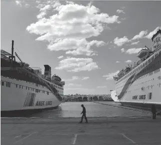  ?? ARIS MESSINIS/AFP/GETTY IMAGES ?? Docked ferries at the port of Piraeus, outside Athens. According to officials, Greece is likely to move ahead with the sale of stakes in assets such as the port along with 14 airports this year.