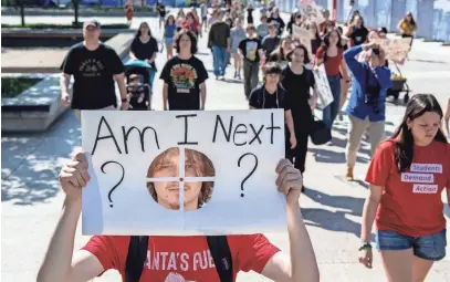  ?? PHOTOS BY NICOLE HESTER/THE TENNESSEAN ?? Will Carlson marches with other Nashville area high school students to protest HB1325 at the Tennessee Capitol in Nashville on Monday.