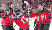  ??  ?? Canada players celebrate their game-winning goal in the final of the World Junior Championsh­ips against Sweden on Friday.