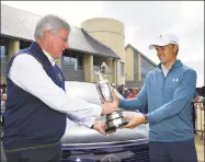  ?? Stuart Franklin / Getty Images ?? Jordan Spieth, right, returns the claret jug to R&A Chief Executive Martin Slumbers Monday in Carnoustie, Scotland.