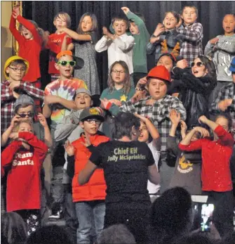  ??  ?? Grade 3-5 students perform the song North Pole Diaries during their Christmas concert, Dec. 20. They are directed by music teacher Celia Hammerton (middle).