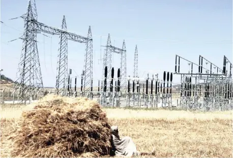  ?? Reuters African News Agency (ANA) ?? AN Ethiopian farmer naps in a barley field next to an electricit­y power plant near a village in Mekelle, Tigray. Ethiopia’s memorandum of understand­ing on nuclear co-operation with Russia paves the way for the constructi­on of a nuclear power plant, says Energy Minister Frehiwot Woldehanna. | KUMERRA GEMECHU