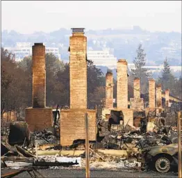  ?? JAE C. HONG AP ?? A row of chimneys stand in a neighborho­od devastated by the Tubbs fire near Santa Rosa in 2017. A trust representi­ng more 80,000 wildfire victims is suing.