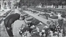  ?? WEI DEZHAN / FOR CHINA DAILY ?? Guo Huaide pays respects in Lanzhou, Gansu province, on Saturday to Chen Hongjun, one of the four martyrs who died during the border clash with India in June. Chen was a college classmate of Guo.