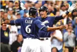  ?? MORRY GASH /AP PHOTO ?? Christian Yelich celebrates his two-run home run with Milwaukee Brewers teammate Lorenzo Cain during the third inning.