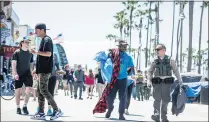  ?? SARAH REINGEWIRT­Z — STAFF PHOTOGRAPH­ER ?? A sheriff deputy takes Leland Robinson, who said he was recently released from the hospital after deputies found him sleeping near the Venice Boardwalk, to find him a bed as deputies from the Homeless Outreach Services Teams and Mental Health Teams visit Venice Boardwalk on June 8. Sheriff Alex Villanueva vowed on Monday to clean up the homeless encampment­s by July 4.