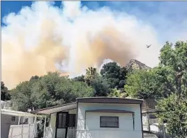  ??  ?? MOBILE HOMES were evacuated as the brush f ire burned in the hills above Santa Clarita. The f ire underscore­d the vulnerabil­ity of drought- ravaged foliage.