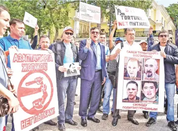  ?? — Reuters photo ?? Opposition supporters attend a protest rally in Almaty, Kazakhstan.