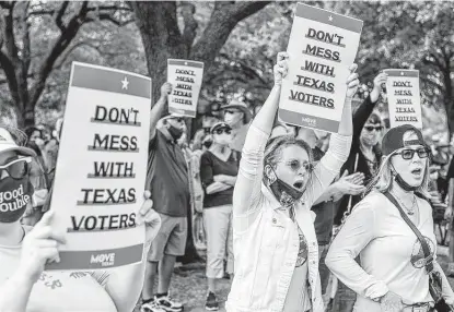 ?? Photos by Matthew Busch / Contributo­r ?? Gina Fant-Simon, center, and Shari Fant-Simon, right, cheer during a voting rights rally Saturday at the Texas Capitol held in response to bills making their way through the Legislatur­e that critics say would restrict voting access for Texans.