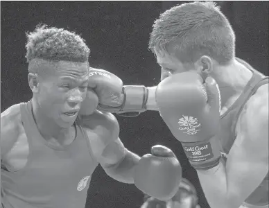  ?? Canadian Press photo ?? Canada’s Thomas Blumenfeld , right, lands a right to the head of Namibia’s Jonas Jonas during their 64kg gold medal boxing final at the Commonweal­th Games Saturday in Gold Coast, Australia. Jonas won the bout with a unanimous decision.