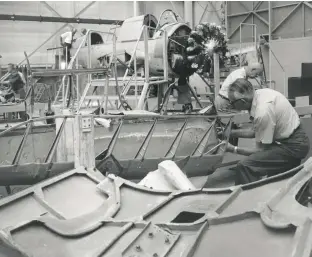  ?? PHOTOS OF KINGFISHER AND USS NORTH CAROLINA COURTESY BATTLESHIP NORTH CAROLINA ?? Clockwise from above: Restoratio­ns on the Kingfisher began in 1970; a year later, the restored Kingfisher sits on the deck of the historic battleship USS North Carolina; the shoreline at Calvert Island today.