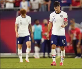  ?? MARK HUMPHREY — THE ASSOCIATED PRESS ?? United States forwards Christian Pulisic (10) and Josh Sargent (9) leave the pitch following a 1-1 draw with Canada in a World Cup qualifier Sept. 5 in Nashville, Tenn.