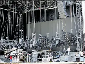  ?? Arkansas Democrat-Gazette/THOMAS METTHE ?? Production crew members set up the stage on Friday in preparatio­n for today’s Guns N’ Roses concert at War Memorial Stadium in Little Rock.