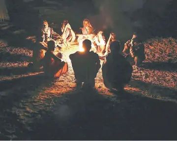  ??  ?? Villagers warm themselves in front of a fire at night in the village of Bhamana, India, on Jan 18. — WP-Bloomberg photo