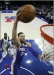  ?? MATT SLOCUM — THE ASSOCIATED PRESS ?? The 76ers’ Ben Simmons (25) goes up for a dunk during the first half against the Memphis Grizzlies, Wednesday in Philadelph­ia.