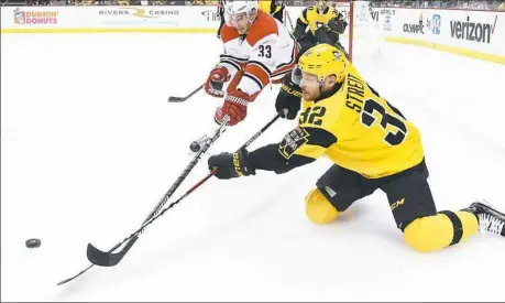  ?? Peter Diana/Post-Gazette ?? Mark Streit battles for a loose puck against the Hurricanes in a game last month. The veteran defenseman, acquired at the trade deadline to provide depth, has yet to play in the postseason, so he sits and waits for his chance to contribute.