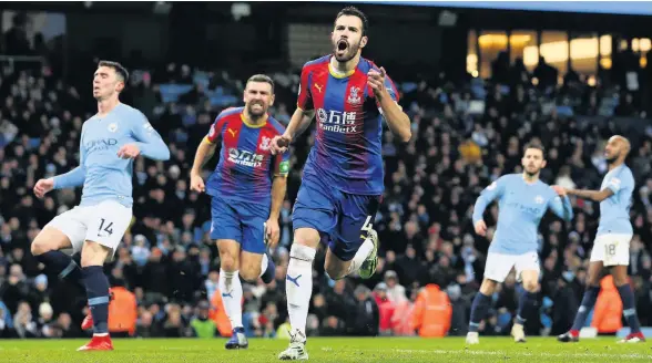  ??  ?? ■ Luka Milivojevi­c celebrates after scoring Crystal Palace’s third goal in their shock win over Manchester City at Etihad Stadium yesterday