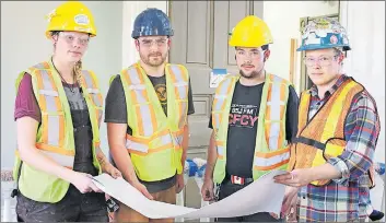  ?? SUBMITTED PHOTO ?? Holland College heritage retrofit carpentry graduates, from left, Jenna MacNeill, Steffen MacEwen, Zackery Bernard and Noah Savary examine blueprints for Province House.