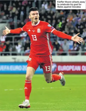  ??  ?? Kieffer Moore wheels away to celebrate his goal for Wales against Slovakia