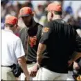  ?? CHRIS CARLSON - AP ?? San Francisco Giants starting pitcher Madison Bumgarner, center, is looked over by manager Bruce Bochy, right, and a trainer after getting hit by a line drive during the third inning of a spring training game against the Kansas City Royals in...