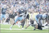  ?? GERRY BROOME — THE ASSOCIATED PRESS ?? North Carolina running back Ty Chandler (19) runs for a touchdown as offensive lineman Jordan Tucker (74) blocks Wake Forest defensive back Traveon Redd (17) during the second half Saturday in Chapel Hill, N.C.